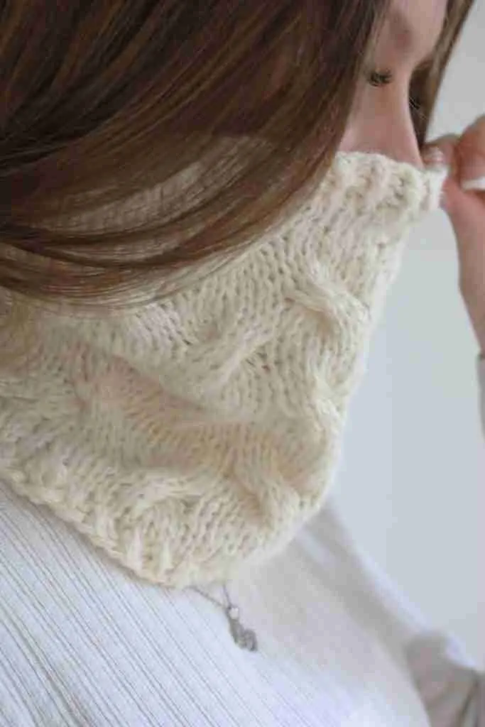 Girl wearing cable knit cowl. Easy cable knitting pattern.
